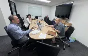 A group of people discuss teaching practice