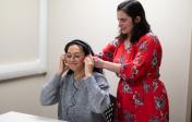 clinician helping patient with earphones