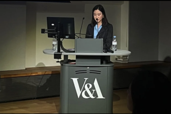 Stephany Noh presenting at grey podium with "V&A" on the front
