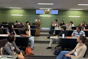 student holding a microphone in a group setting