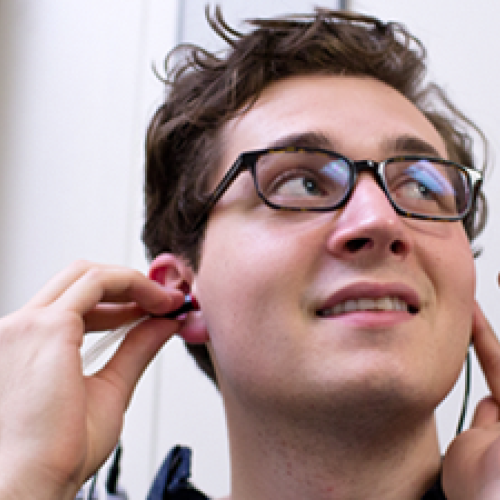 Image of student testing hearing device