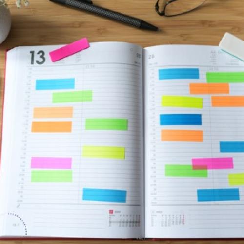 Open calendar with a lot of colorful sticky notes
