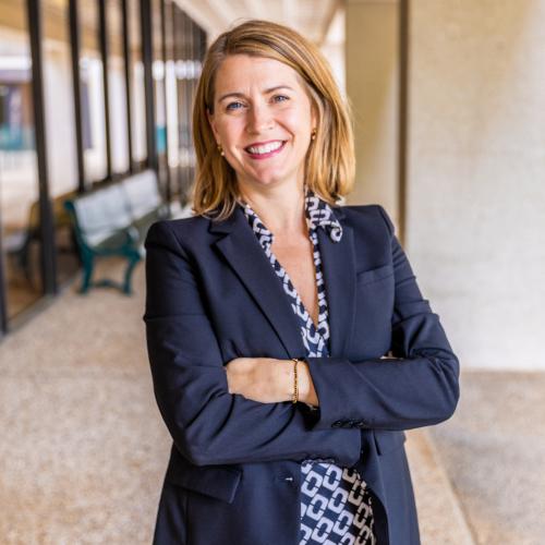 Headshot of Jessica Hughes Wagner, Deputy Director of the Center for Health Communication. A white woman with shoulder-length blonde hair in a navy blazer and patterned blouse smiling at the camera with her arms crossed.