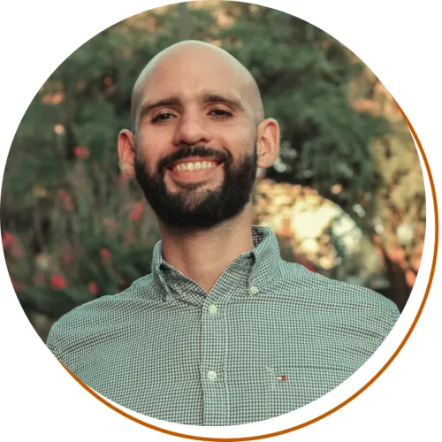 Luis Rivera-Figueroa Headshot, shoulders up, Green Shirt, Trees in background