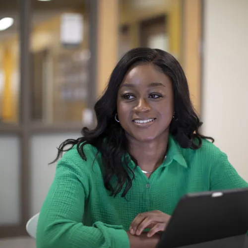 student smiling at a desk