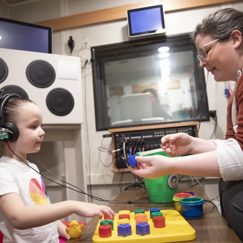 faculty with child testing hearing