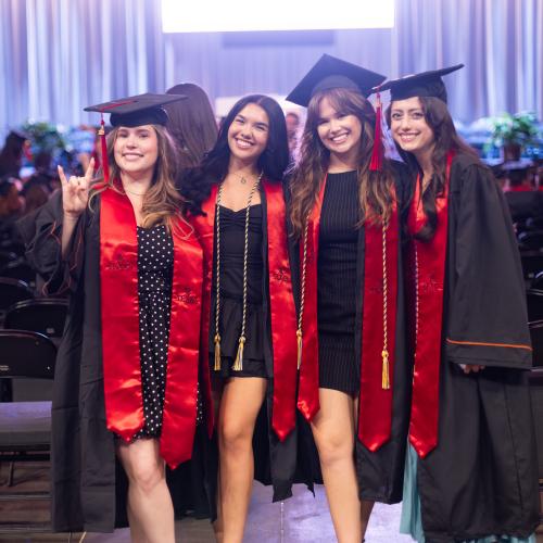 4 students in caps and gowns