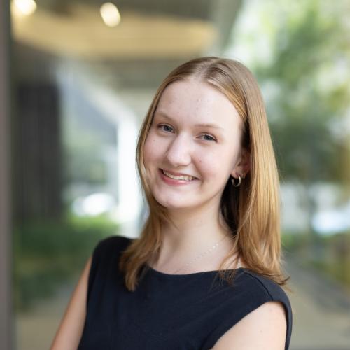A portrait of a young woman with blonde hair.