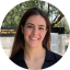 Headshot of Eileen Artigas, Program Coordinator for the Center for Health Communication. A woman with long dark brown hair, smiling, wearing a black shirt.