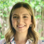 Headshot of Paloma Gray, Sr. Program Coordinator for the Center for Health Communication. A woman smiling with dark blonde hair, gold earrings, a gold necklace, and wearing a pale pink button down shirt with floral print.