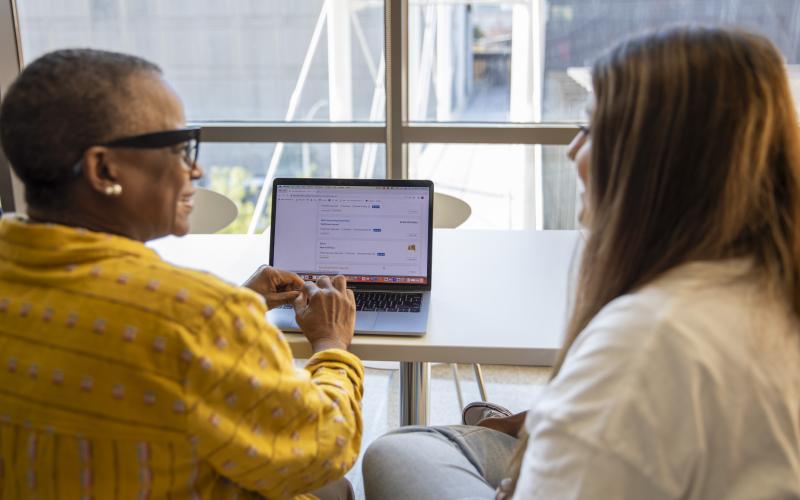 student and instructor facing a screen