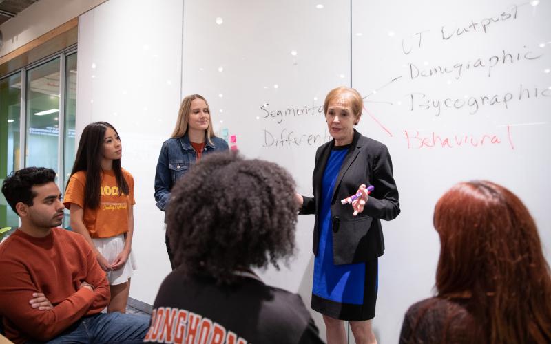 professor teaching at white board