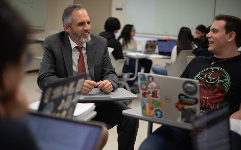 Professor sitting with student