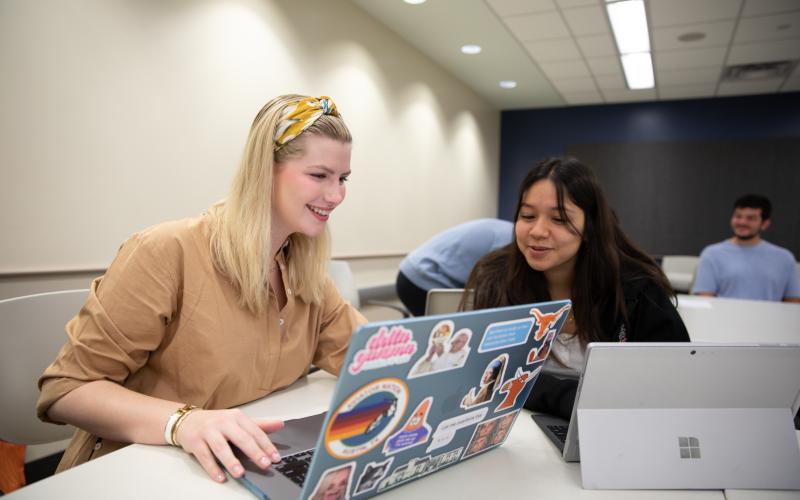 two students working on a computer together