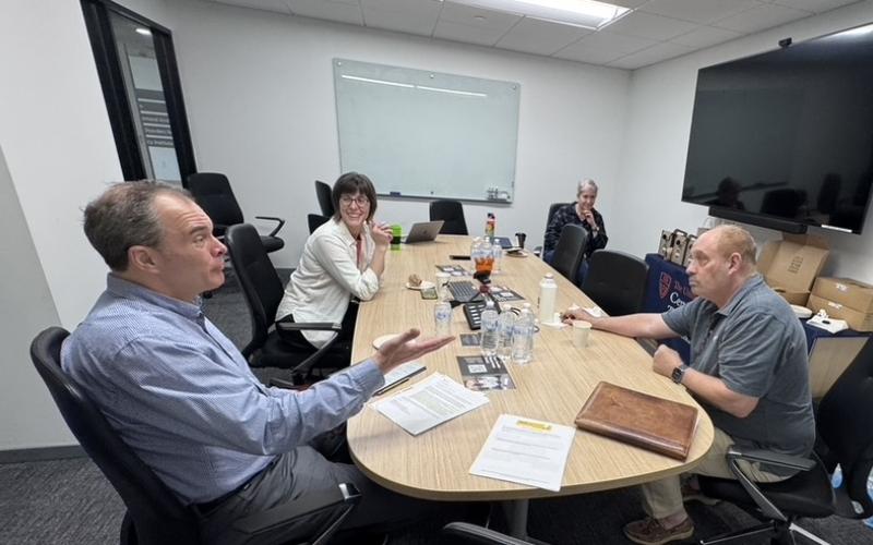 Faculty members discussing teaching topics in a conference room
