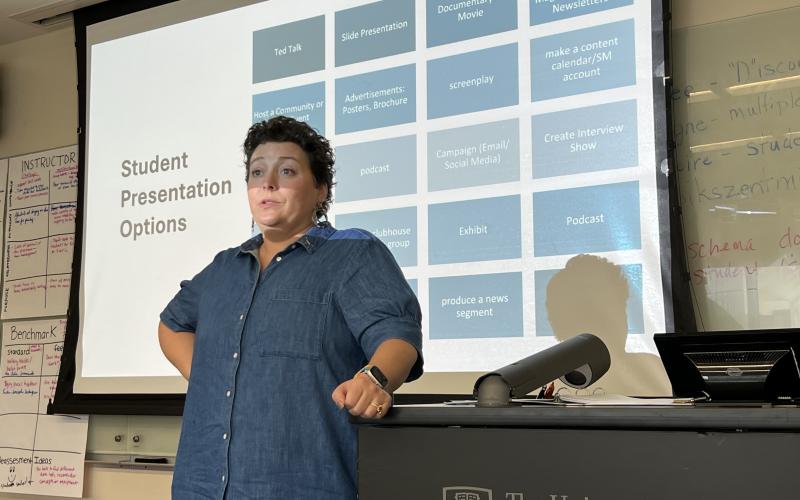 Dr. Czimskey standing in front of a classroom and giving instructions and guidelines on student's pbl product format choices