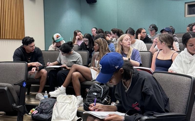 Students working in groups in a lecture hall
