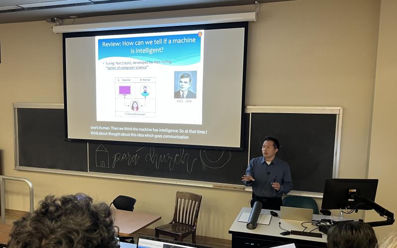 Image depicts professor using closed captions while presenting.