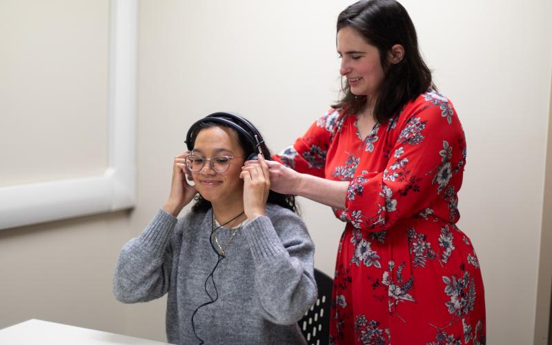clinician helping patient with earphones