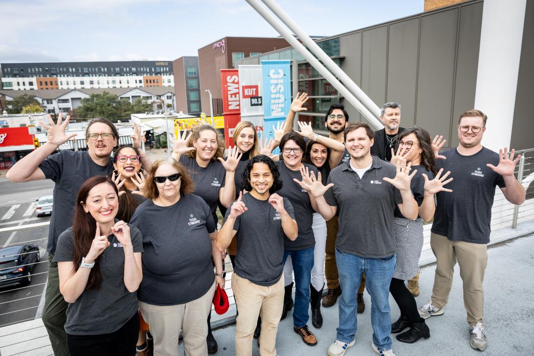 group photo of texas standard staff standing on the moody bridge celebrating 10 years